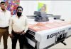 Santosh Nair’s Skytek Technologies in Bangalore Chetan Singhwi, director of RM Enterprises, dealer for Skytek Technolgies (Left) and Joesph, director of Ad India Proprietor (Right) standing with TheBigPrinter UV Flatbed press