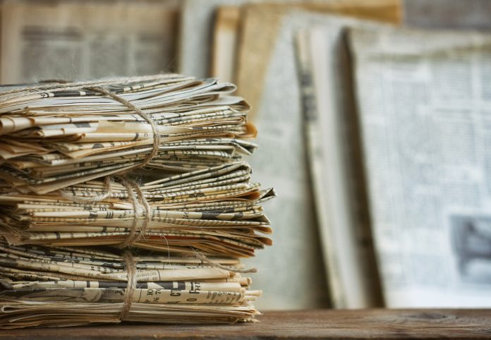 Waste paper pile in vintage style newspapers
