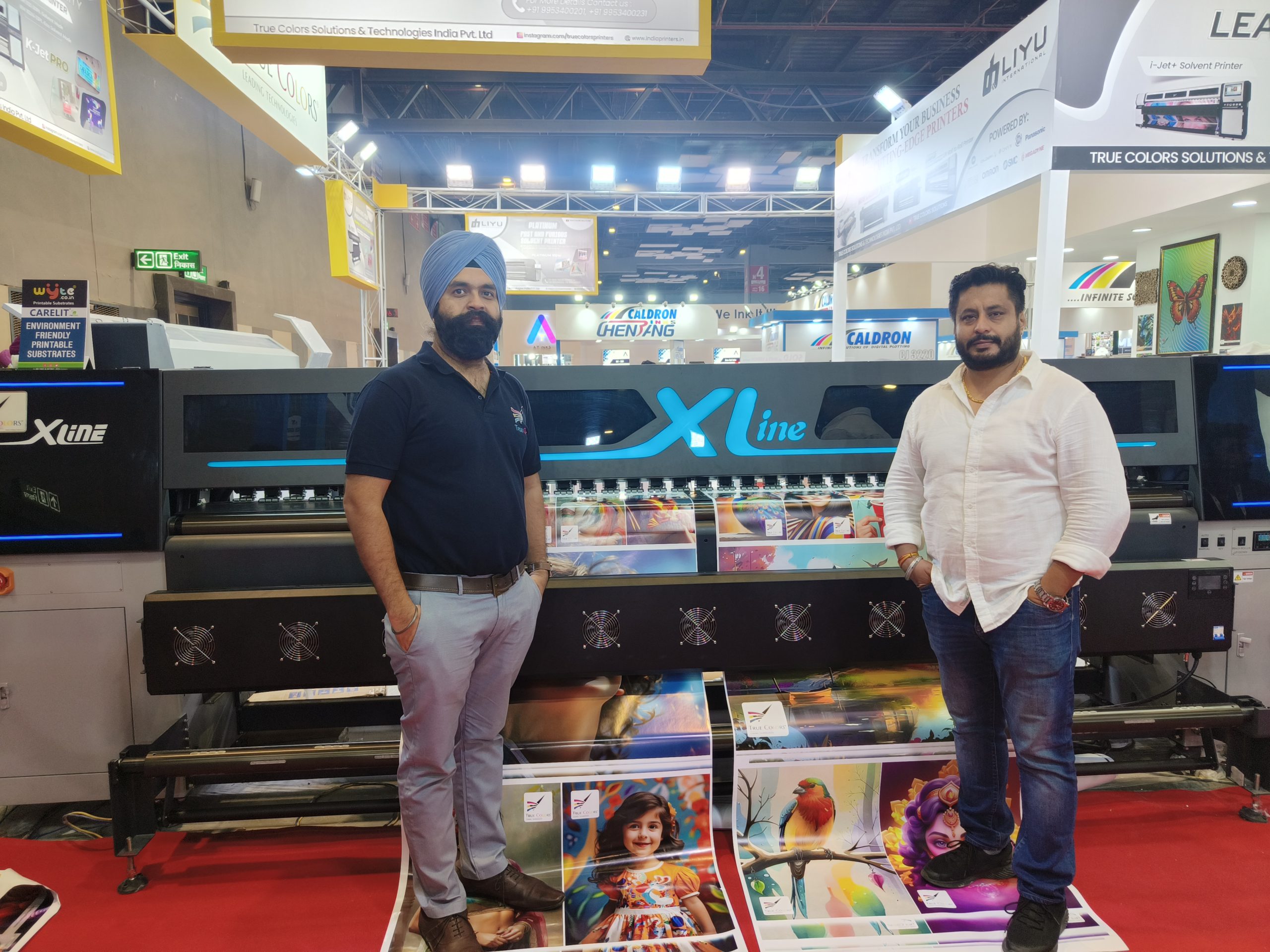 (L–R): Charanjeet Shah and Tandeep Singh, both directors at True Colors with the Xline PN 3302-EC large format inkjet printer. Photo IPP