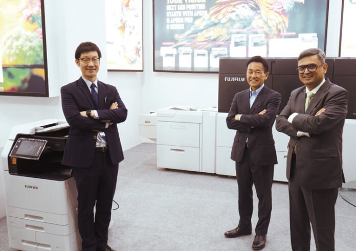Koji Wada, managing director of Fujifilm India (second from right) and Priyatosh Kumar, associate director and head of Graphic Communication & Device Technology, Fujifilm India (extreme right) at the Fujifilm stand at Pamex. Koji Wada, managing director of Fujifilm India (second from right) and Priyatosh Kumar, associate director and head of Graphic Communication & Device Technology, Fujifilm India (extreme right) at the Fujifilm stand at Pamex.